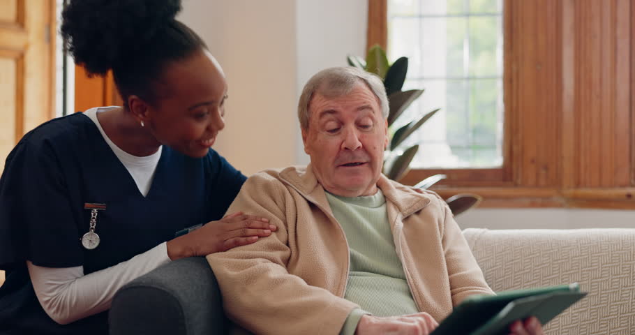 Healthcare, tablet and an elderly man with a caregiver during a home visit for medical checkup in retirement. Technology, medicine and appointment with a nurse talking to a senior patient on the sofa Royalty-Free Stock Footage #1109480777