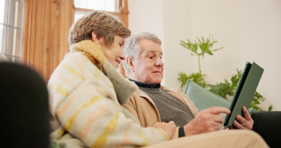 Home, love and senior couple with tablet, funny and social media with online reading, post and website info. Apartment, elderly woman and happy old man with technology, laughing and search internet