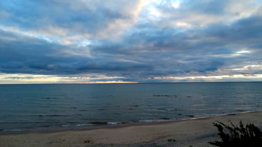 Northern shores of Lake Michigan at sunset. LtoR motionlapse on a mild September night. From mostly cloudy to clear skies.