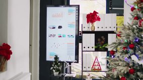 Dolly out shot of empty festive ornate office workspace with beautiful Christmas tree and pine wreaths. Xmas adorn professional workplace ready for festivities before winter holiday season vacation - Powered by Shutterstock - Get 15% off with code: PIKWIZARD15