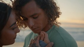 Closeup love couple bonding on sea beach. Passionate girl and guy touching gently. Loving young man kissing girlfriend hands tenderly. Teen lovers enjoying romantic date together on calm ocean coast - Powered by Shutterstock - Get 15% off with code: PIKWIZARD15