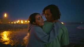 Tender youngsters enjoy night ocean beach closeup. Two people walking water shore spending evening together. Young lovers bonding on romantic date. Gentle man kissing girlfriend. Nature leisure time  - Powered by Shutterstock - Get 15% off with code: PIKWIZARD15