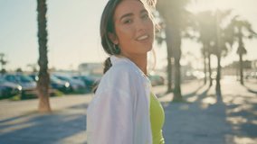 Cheerful woman turning camera walking alley portrait. Happy lady moving sunny tropical city enjoy holiday vacation alone closeup. Smiling girl crossing palm trees street. Weekend activity concept - Powered by Shutterstock - Get 15% off with code: PIKWIZARD15