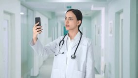 Indian female doctor talking on video call