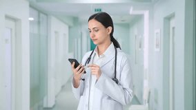 Indian female doctor using phone - Powered by Shutterstock - Get 15% off with code: PIKWIZARD15