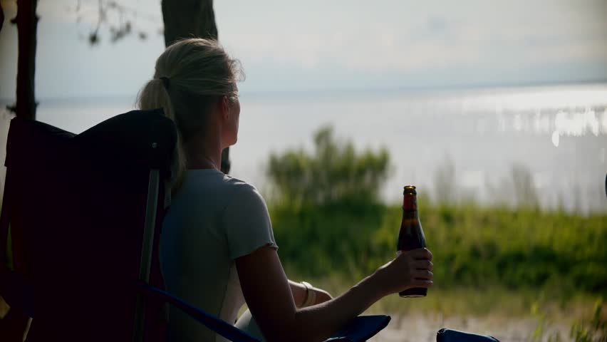 Beer Bottle Cool Beverages. Beachside Celebration Picnic Drinks. Festive Drinking Bottled Beer. Romantic Summer Party Atmosphere. Vocation Vibes Tasting Beer. Celebration Euphoric Moments Having Fun Royalty-Free Stock Footage #1109488447
