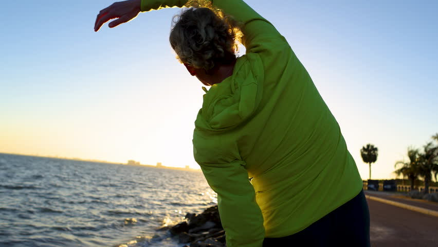 Female exercising at sunrise keeping a positive energy life balance with lens sun flare travel tourism Tampa Florida