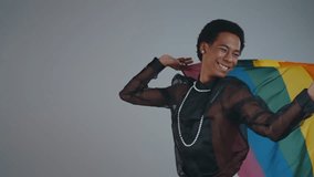 Gender fluid young man wearing fashionable clothes posing in studio on colored backgrounds - Powered by Shutterstock - Get 15% off with code: PIKWIZARD15