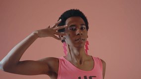 Gender fluid young man wearing fashionable clothes posing in studio on colored backgrounds - Powered by Shutterstock - Get 15% off with code: PIKWIZARD15