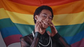 Gender fluid young man wearing fashionable clothes posing in studio on colored backgrounds - Powered by Shutterstock - Get 15% off with code: PIKWIZARD15