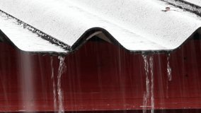 In the rainy season, it rains from the roof of a wooden house. Macro Video.