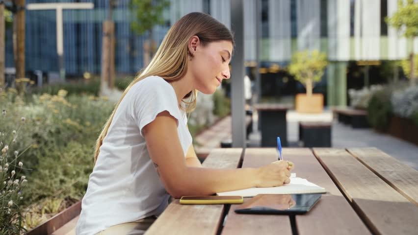 Inspired woman studying and writing notes at the University - Student girl thinking and working on project  Royalty-Free Stock Footage #1109497433