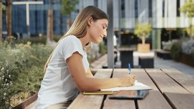 Inspired woman studying and writing notes at the University - Student girl thinking and working on project  - Powered by Shutterstock - Get 15% off with code: PIKWIZARD15