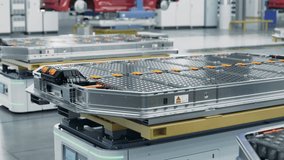 Electric Car Battery Packs loaded on AGV inside Modern Automotive Smart Factory. EV Production Line on Factory. High Performance Electric Car Autonomous Manufacturing Processes - Powered by Shutterstock - Get 15% off with code: PIKWIZARD15
