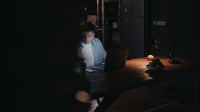 Man working late night on laptop in dark office - Powered by Shutterstock - Get 15% off with code: PIKWIZARD15