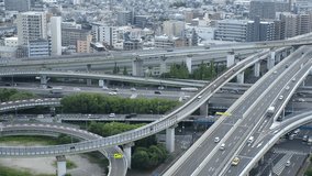 HIGASHI OSAKA, JAPAN - JULY 2023 : Aerial view of high way, road junction and cityscape of downtown district in daytime. Japanese transportation, street traffic and urban city concept video.