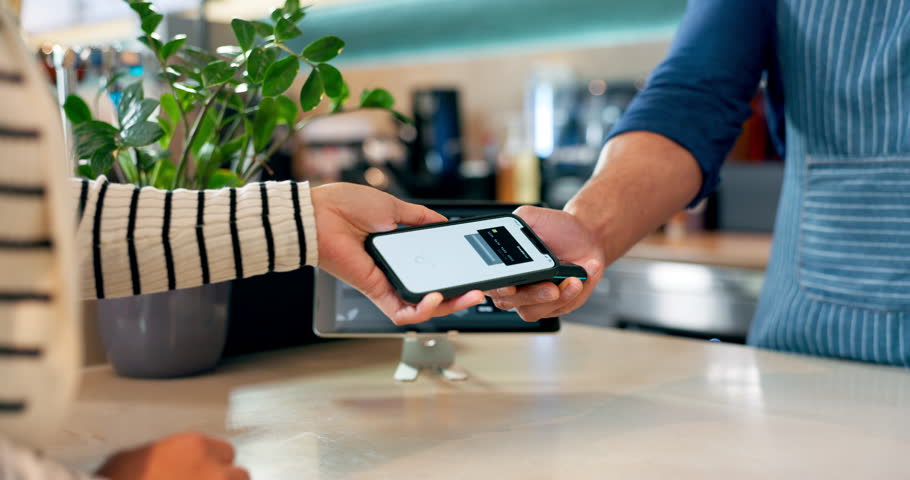 Customer, barista and pos machine with phone for payment, transaction or checkout at cafe. Closeup of person, hands and paying with smartphone tap for coffee, tea or beverage at cafeteria restaurant