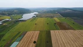 Splendid scene of agricultural land in summer. Footage from a bird's eye view. Agronomic industry. Agrarian region of Ukraine, Europe. Cinematic drone shot. Filmed in UHD 4k video. Beauty of earth.