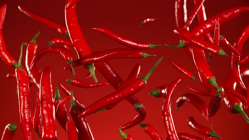 Super Slow Motion of Flying Red Chilli Peppers. Filmed on High Speed Cinema Camera, 1000 fps. Speed Ramp Effect.