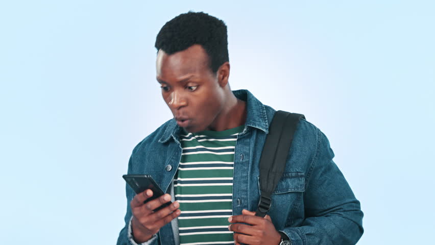 African man, phone and surprise news in studio with smiling, happy and mockup by blue background. Black guy, announcement and notification on social media, technology and excited by positive alert