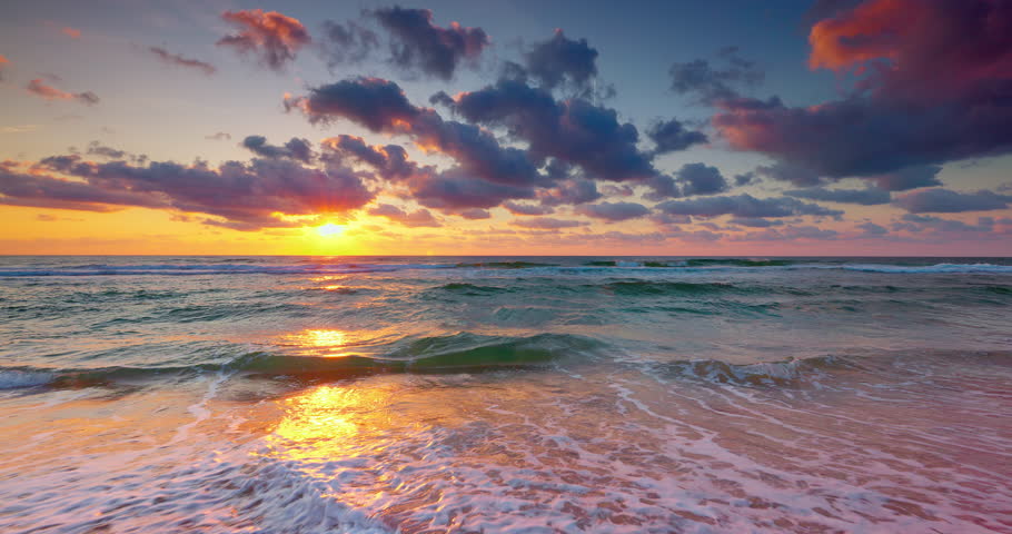 Sea horizon and scenic sunrise over splashing ocean waves and beach shore, tropical landscape 4K video