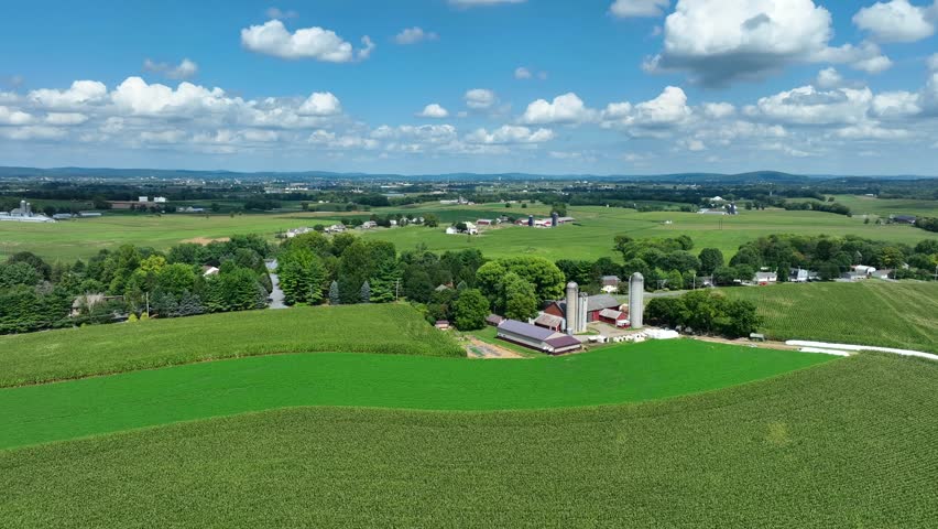 Sprawling farmland in USA. American farm scene in rural USA. Agriculture theme on summer sunny day. Aerial.