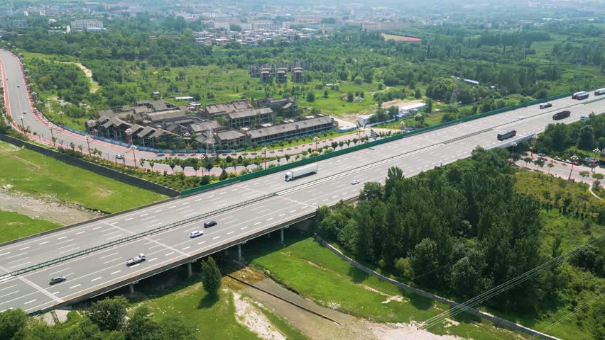 Aerial of Lianhuo Expressway highway, Huayin, Shaanxi, China. This modern roadway exemplifies China's commitment to infrastructure development and efficient connectivity, UHD. Royalty-Free Stock Footage #1109532287