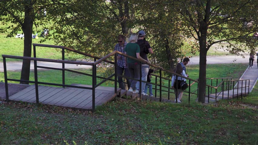 Moscow region, Russia - September 23, 2023: People walk, relax, take photos in the park near the Church of the Sign of the Blessed Virgin Mary in Dubrovitsy