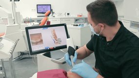 Dentist scans the patient's teeth using the CEREC scanner. Modern dentistry. The dentist uses a 3D dental intraoral scanner to scan the patient's teeth - Powered by Shutterstock - Get 15% off with code: PIKWIZARD15