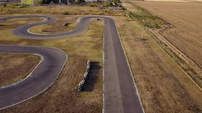 Aerial 4k footage of a karting race track. Drone shot of a Kart Circuit. Short circuit karting racing seen from above. High angle video of carts racing on a track.
