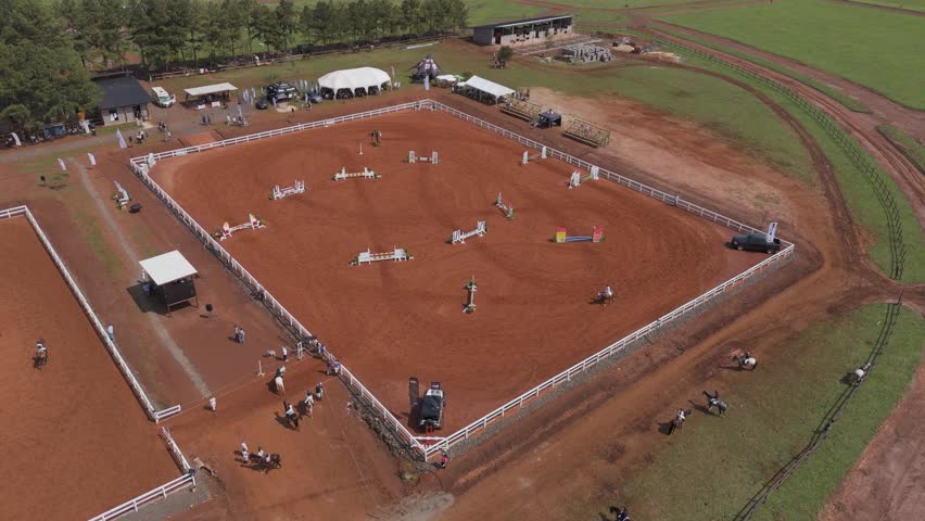 Aerial View of Thrilling Horse Jumping Event, Showjumping event in the horse jumping Barn Royalty-Free Stock Footage #1109542001