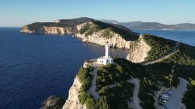 Drone aerial video of Doukato (Cape Lefkada) lighthouse, Lefkada island, Greece, Ioinan Sea in sunset colors