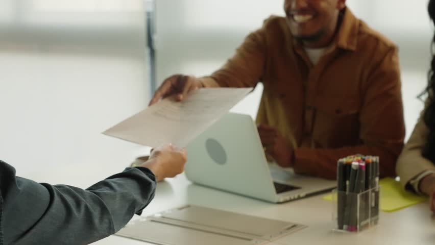 Diverse Business people signing contract at meeting with business partners. Business people shaking hands in deal after successful negotiations in office. Trans gender sucessful person
