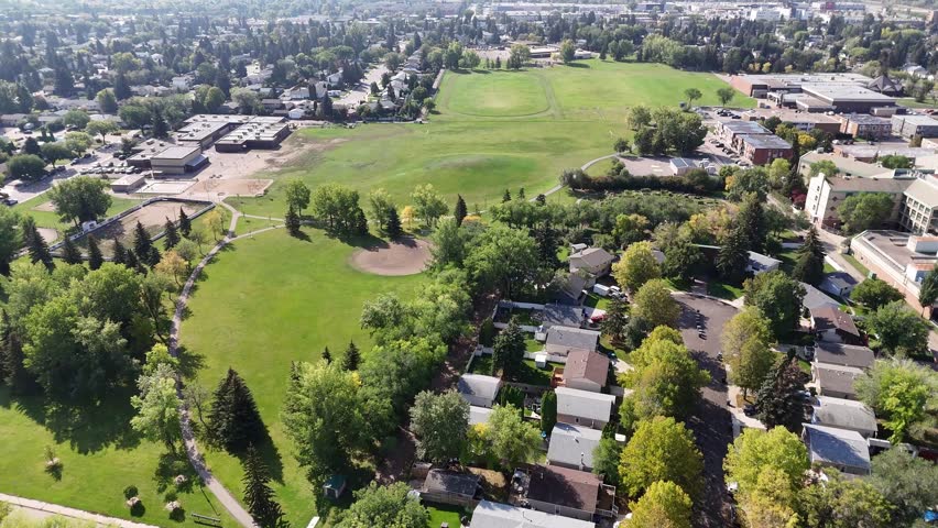 Fly over College Park, an iconic neighborhood in Saskatoon, Saskatchewan. This aerial drone footage captures the essence of the area, spotlighting its academic roots  peaceful residential streets