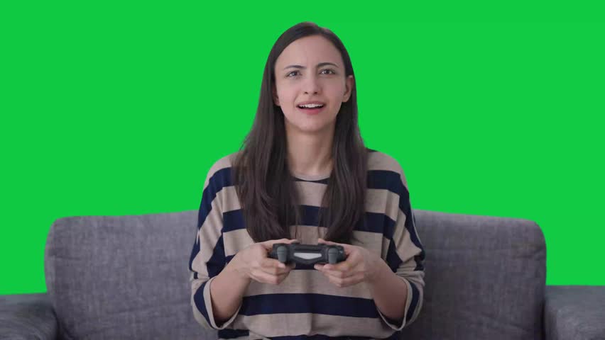 Happy Indian girl wins a video game Green screen