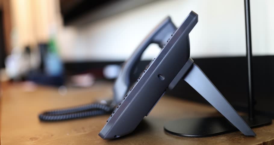 Closeup of landline office telephone with man hand holding receiver. Answer call Royalty-Free Stock Footage #1109552241