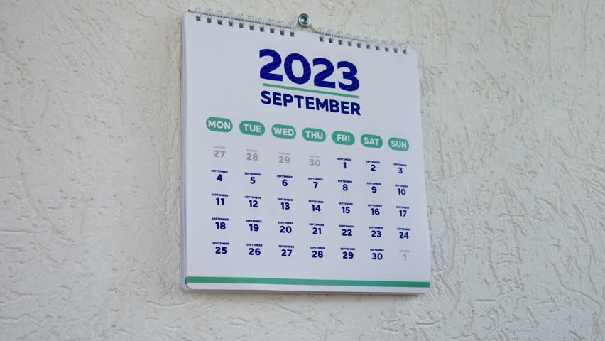 Close-up of two male hands tearing off the wall calendar September page 2023 followed by the next one with marked Halloween date on it Royalty-Free Stock Footage #1109553369
