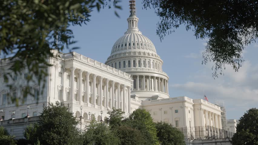 Establishing exterior shot during the day time and view of white capital building on United States of American mall with congress senators and house of representatives chambers inside