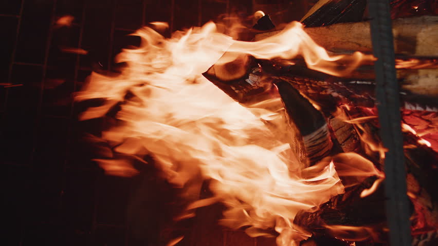 Flame, fire close-up, slow motion. Stone barbecue firewood, open brick oven for cooking kebabs, meat, fish and other food dishes on fire indoors. Restaurant kitchen, pizza oven and BBQ grill. Vertical Royalty-Free Stock Footage #1109562069