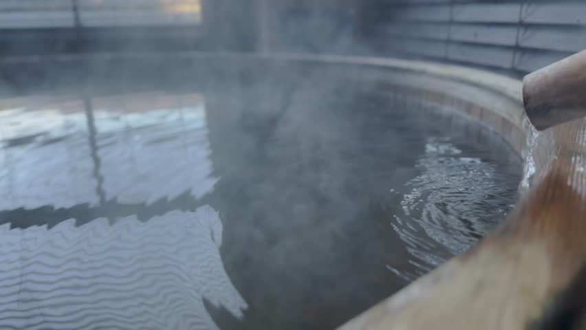 The hot spring water flows out slowly, spreading soft ripples. Royalty-Free Stock Footage #1109568723