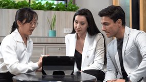 group of diversity business people asian woman and caucasian man talking with using tablet computer in lobby or restaurant . appointment to date in meeting at office. seller and customers insurance - Powered by Shutterstock - Get 15% off with code: PIKWIZARD15