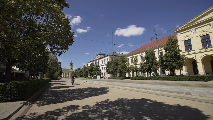City center in Debrecen, Hungary in summer. Modern cinematic 4K tracking dolly shot. 