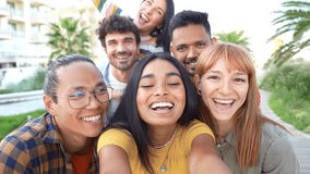 Multiracial friends taking selfie video with smart mobile phone outside - Happy young people having fun talking on city street - Life style concept with guys and girls hanging out on a sunny day  - Powered by Shutterstock - Get 15% off with code: PIKWIZARD15