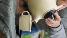 Autumn tea party. Vertical video. Female hands pouring tea in tea mug outside.  - Powered by Shutterstock - Get 15% off with code: PIKWIZARD15