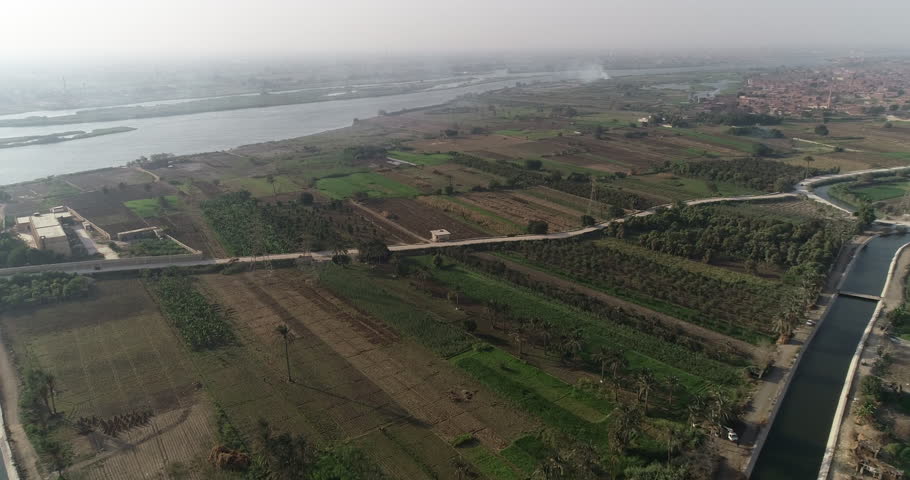 Aerial shot for The River Nile of Egypt surrounded by the green lands of the Nile Valley