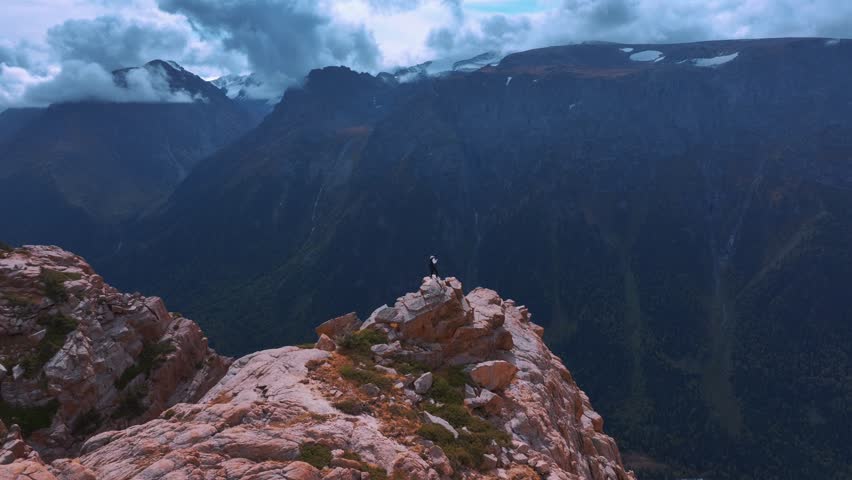 Aerial view of man standing on the mountain cliff