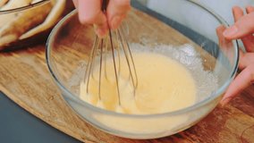 Kneading liqud dough for a pie. Close-up shot of kitchen table. Cooking in the kitchen. - Powered by Shutterstock - Get 15% off with code: PIKWIZARD15