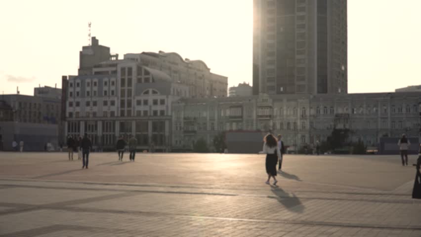 Unrecognizable pedestrians walk along a sunlit square of a big city Royalty-Free Stock Footage #1109595929