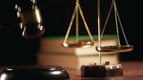 A judge is hitting gavel off a block in courtroom. Close up of scales of justice and legal lawyer books or codex. Sentence or win at auction. Law or legal system and jurisprudence or court concept. - Powered by Shutterstock - Get 15% off with code: PIKWIZARD15