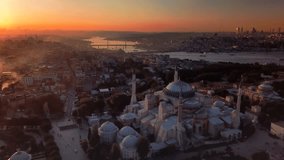 Dome of Hagia Sophia and the Goldenhorn shines in distance at sunset over historic old Istanbul. Chimney smokes from houses rises to sky against bright lights of the sun on a cold winter day
 - Powered by Shutterstock - Get 15% off with code: PIKWIZARD15
